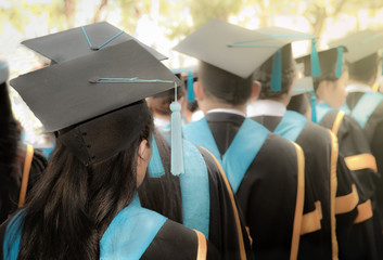 Selective focus on bachelor degree woman graduates in commencement graduation ceremony row, metaphor education, success, concept, background