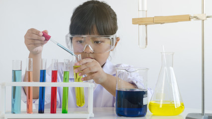 asian children girl testing chemical in laboratory.