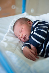 Wall Mural - Newborn baby laying in crib in prenatal hospital