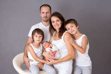 Wall Mural - Beautiful family portrait, father, mother and three boys, looking happily at camera