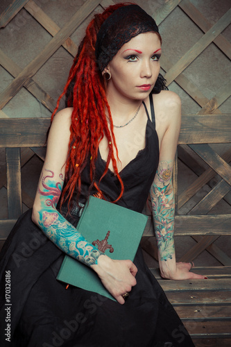 Tattooed Girl In A Black Dress With Orange Dreadlocks Girl