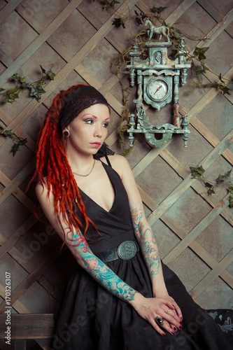 Tattooed Girl In A Black Dress With Orange Dreadlocks Girl