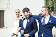 © Lumi Images - Bridegroom and wedding guest embracing