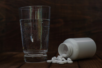 Aufkleber - Bottle for pills on a brown wood table. Beautiful brown background. 