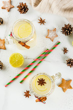 Fall And Winter Drinks. Christmas Holiday Beverage. Festive Snowball Cocktail With Lime Juice, Cinnamon, Liqueur, Sugar And Anise Stars. On White Table With Christmas Decoration, Copy Space Top View
