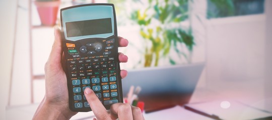 Fototapete - Composite image of hands of businesswoman using calculator