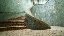 Panning Shot Of Spiral Staircase Of Underground Crossing In Tunnel At Fort Canning Park, Singapore