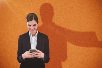Poster - Composite image of smiling businesswoman using mobile phone