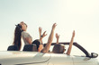 © fotofabrika - Smiling friends driving car near the sea and having fun