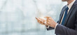 © bunditinay - Business man using smart phone on interior space with futuristic technology connection shape over the network connection background
