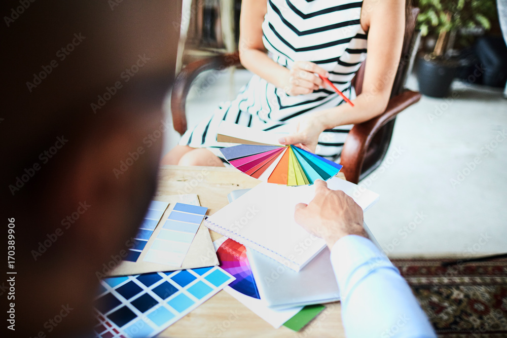 Over shoulder view of unrecognizable young interior designer asking ...