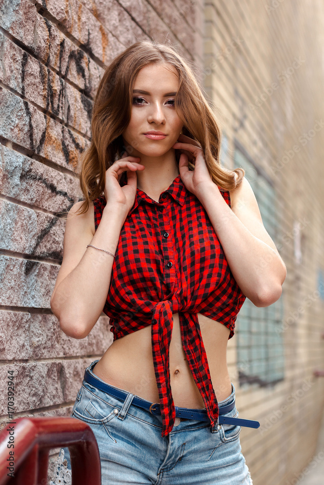 portrait of beautiful young brunette woman with long curly hair on ...