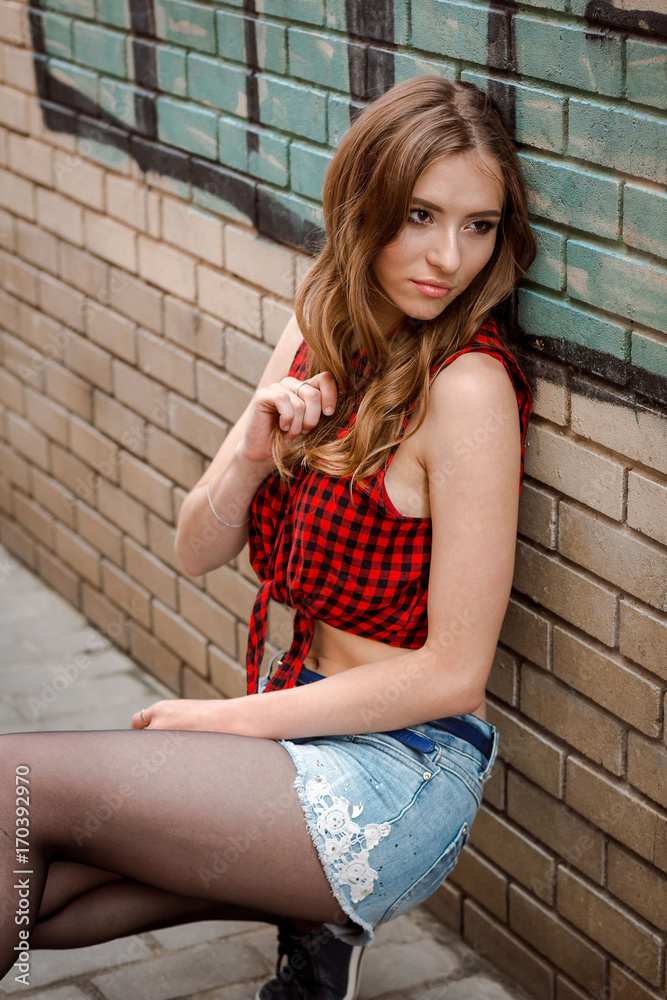 portrait of beautiful young brunette woman with long curly hair on ...