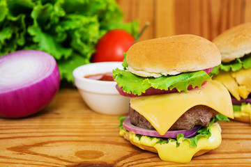 Delicious handmade burger on wooden background