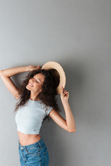 Wall Mural - Happy woman with hat posing isolated