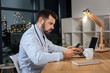 © zinkevych - Smart male doctor looking at his smartphone screen