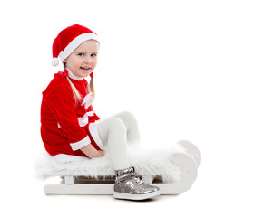 Sticker - joyful little girl in santa suit sitting on a sleigh