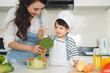 © makistock - Happy family in the kitchen. Mother and child daughter are preparing the vegetables and fruit.
