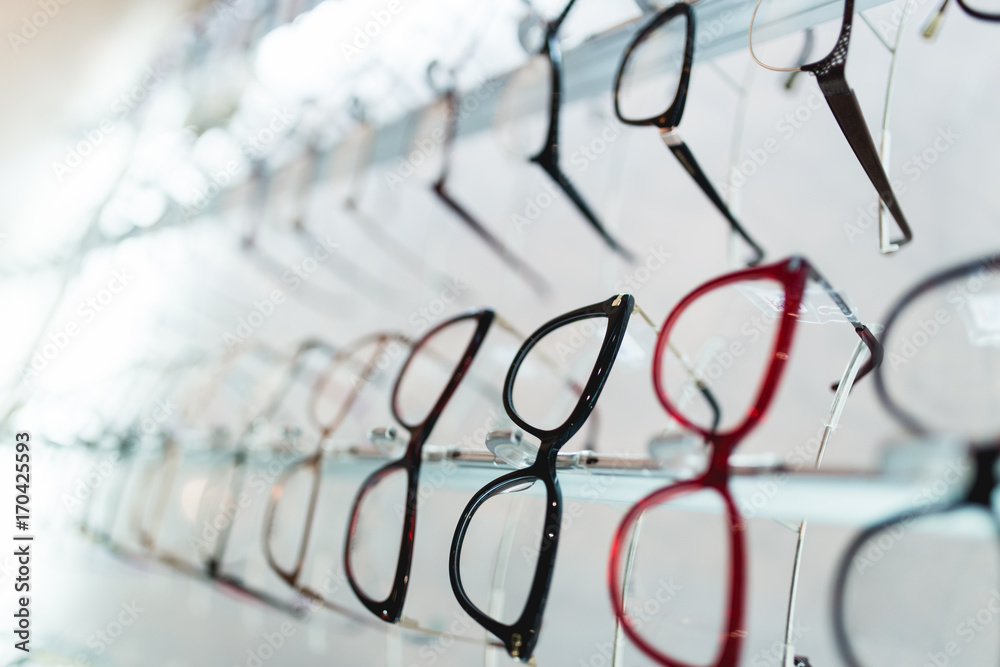 Eyeglasses frames in optical store. - obrazy, fototapety, plakaty 