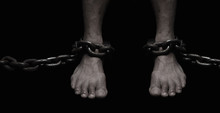 Victim, Slave, Prisoner Male Foor Tied By Big Metal Chain. People Have No Freedom Concept Image.