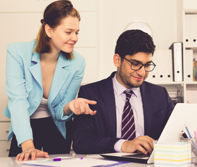 businessman and businesswoman working together