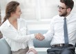 © ASDF - handshake of manager and client in the office lobby