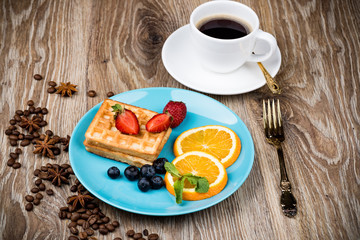 Wall Mural - Cup of coffee and pastry on wooden background