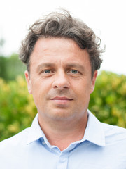 portrait of handsome man in blue shirt outdoors in summer day