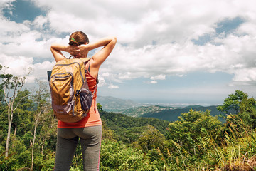 Canvas Print - hiker with backpacker enjoying view beatiful forest and coast