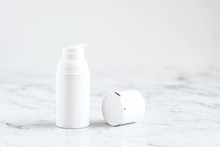 White Bottle Of Cosmetic Product  On White Marble Table. Cream, Cleancer, Moisturizer, Lotion. Branding Mock Up. 