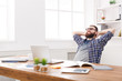 © Prostock-studio - Young relaxed businessman with laptop in modern white office