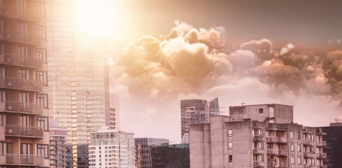 Poster - Composite image of scenic view of bright orange sun over clouds