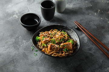 teriyaki salmon and soba noodle served with sesame seeds and chives