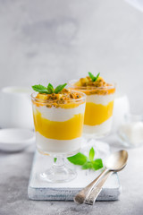 delicious mango,  passion fruit and cream cheese layered dessert on glasses