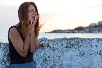 Young  woman feeling sad on the pier