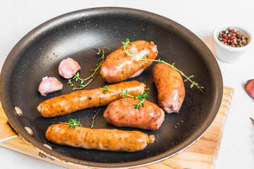 Wall Mural - Grilled barbecue chorizo meat sausages in a frying pan