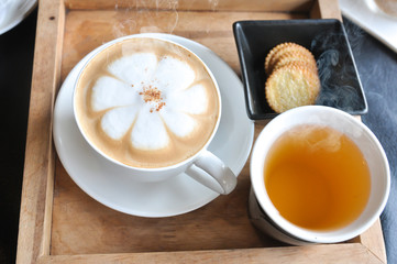 Wall Mural - Coffee cup in coffee shop,Cup of coffee on a wooden table,cup of coffee on table in cafe,cup of cappuccino