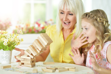 little girl playing with mother