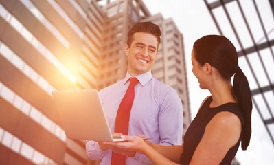 Poster - Composite image of businessman and businesswoman are holding a