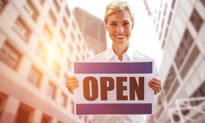 Poster - Composite image of portrait of happy female owner holding open