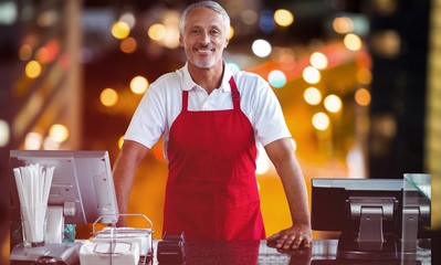Poster - Composite image of portrait of male owner standing at counter