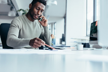 african male architect working in office