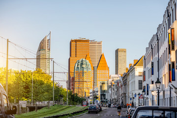 Wall Mural - Street view on the modern office district with skyscrapers during the sunset in Haag city, Netherlands