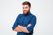 © Drobot Dean - Young bearded man with folded hands smiling to camera