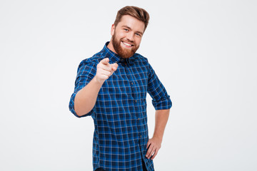 Wall Mural - Cheerful bearded man pointing at camera isolated