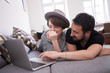© Gonzales Photo - Young couple relax on the couch in front of the computer