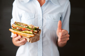 Poster - girl showing thumb holding a sandwich