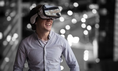 Poster - Composite image of smiling young man wearing virtual reality