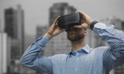 Poster - Composite image of low angle view of man using virtual reality