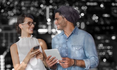 Wall Mural - Composite image of smiling woman and man holding a phone and